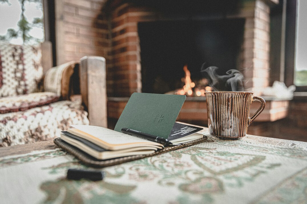 Writing desk with a laptop, notebook and coffee