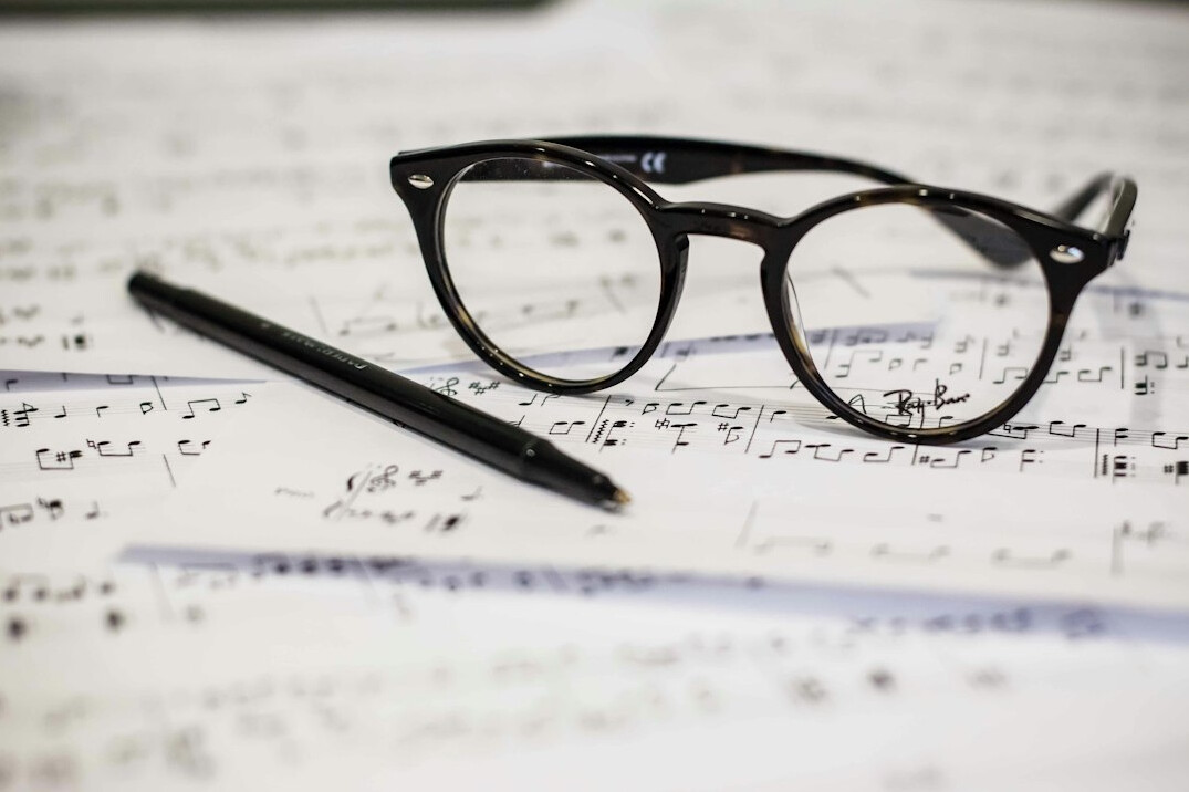 Hands reviewing documents with a pen on a desk